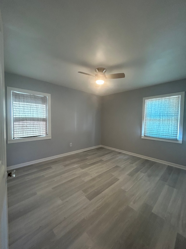 spare room with hardwood / wood-style flooring and ceiling fan