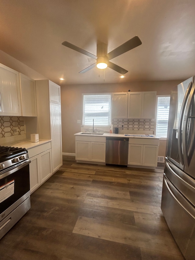 kitchen featuring sink, stainless steel appliances, dark hardwood / wood-style floors, and white cabinets