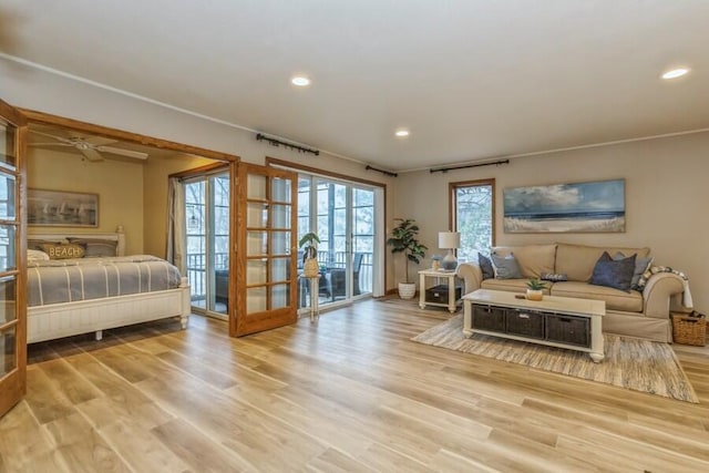 living room with french doors and light hardwood / wood-style flooring