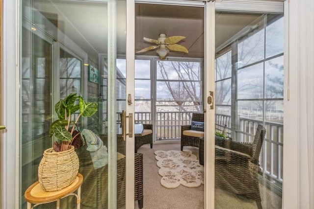 sunroom / solarium featuring ceiling fan