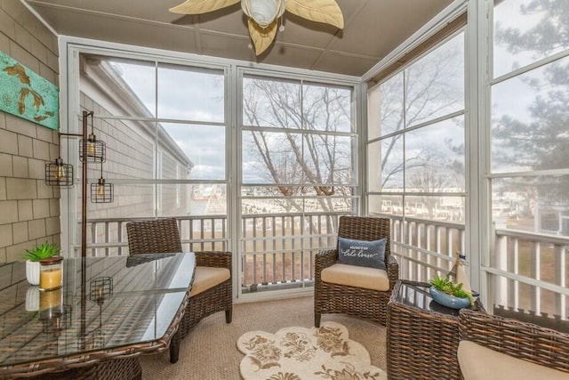 sunroom / solarium featuring ceiling fan