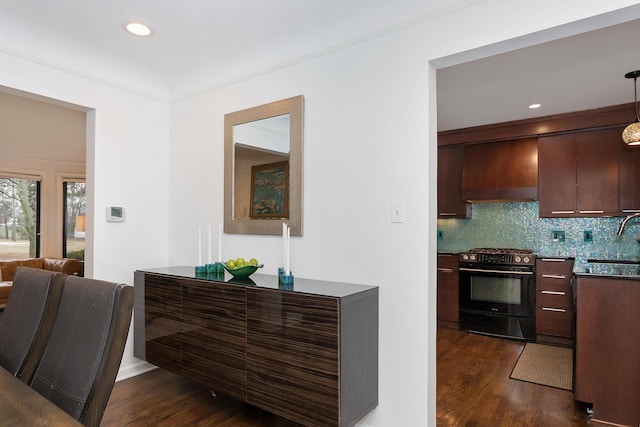 kitchen featuring premium range hood, black range with gas cooktop, sink, tasteful backsplash, and dark hardwood / wood-style flooring