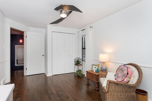 sitting room featuring dark hardwood / wood-style floors and ceiling fan