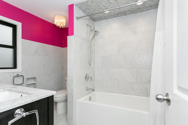 full bathroom featuring shower / bath combo, tile walls, vanity, and toilet