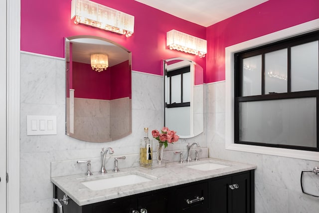 bathroom featuring vanity and tile walls