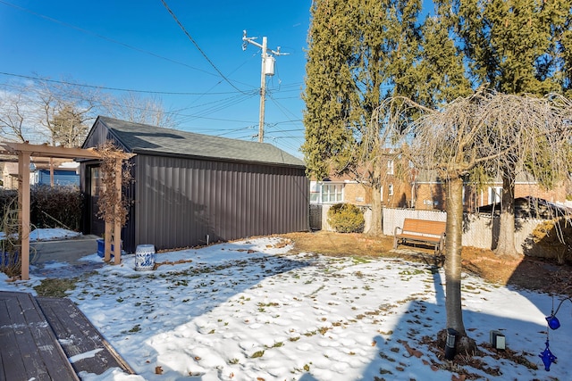 yard layered in snow with an outdoor structure