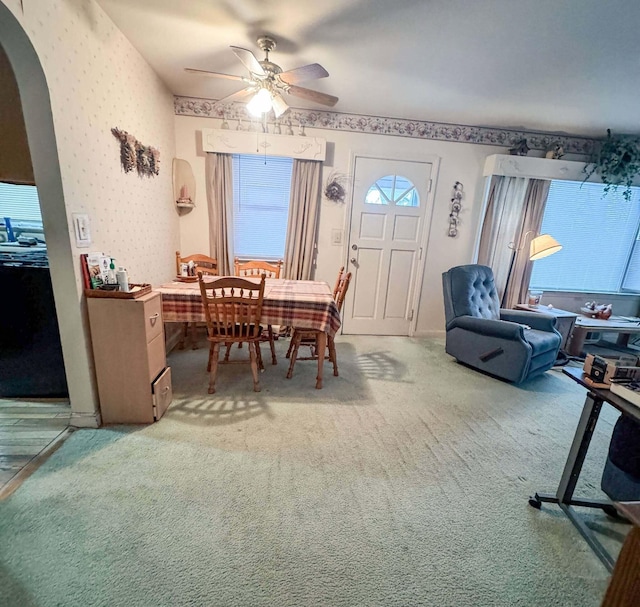 dining space with ceiling fan and carpet floors