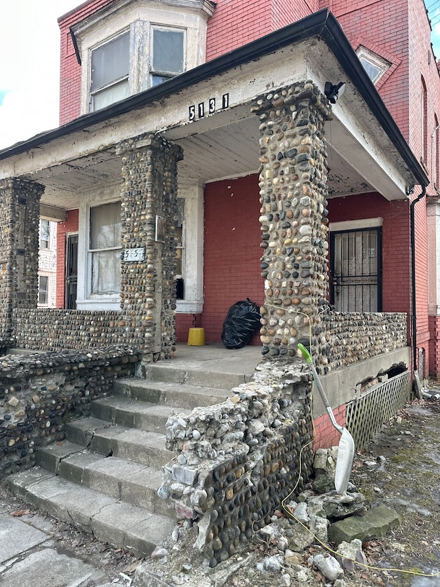 view of exterior entry with covered porch