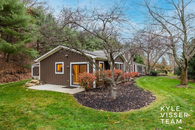 rear view of house featuring a yard and a patio area