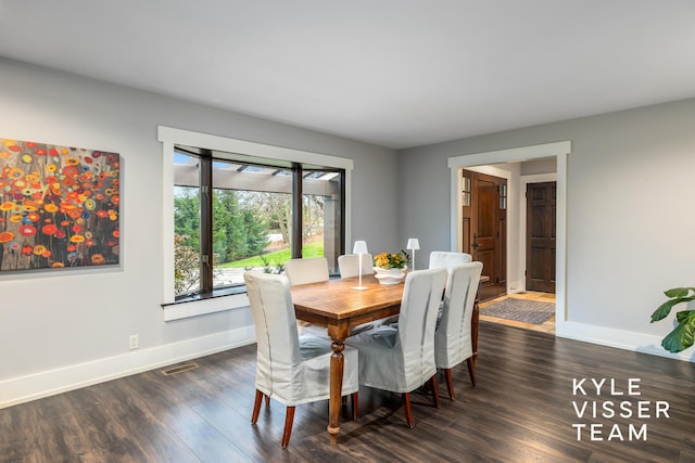 dining area with dark hardwood / wood-style flooring