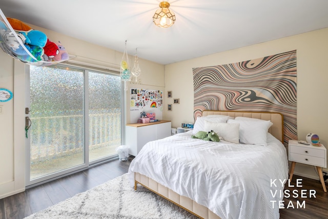 bedroom with wood-type flooring and access to exterior