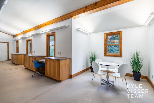 dining space with lofted ceiling with beams