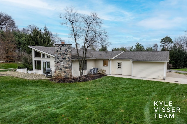 back of property featuring a wooden deck, a yard, and central air condition unit