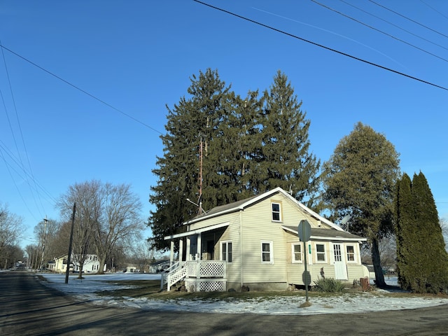 view of side of property featuring covered porch