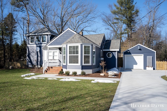 view of front of property featuring a garage, an outdoor structure, and a front lawn