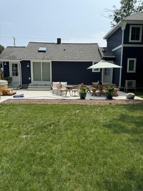 rear view of house featuring a yard and a patio area