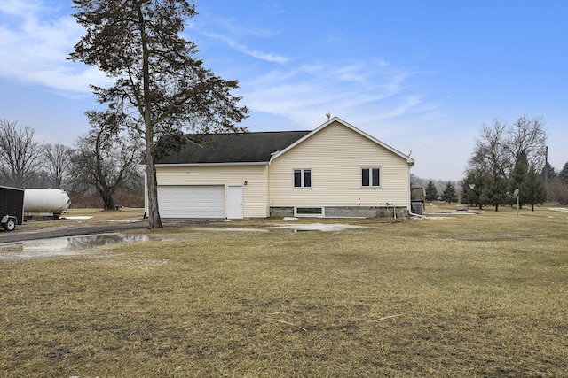 view of property exterior featuring a garage and a lawn