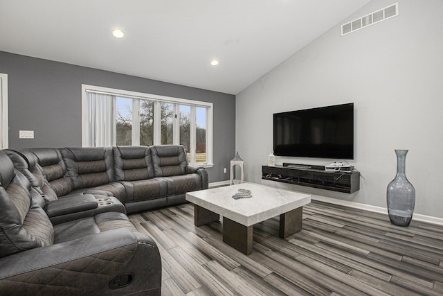 living room with hardwood / wood-style flooring and lofted ceiling