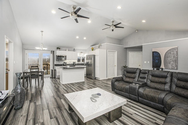 living room featuring high vaulted ceiling, dark hardwood / wood-style flooring, and ceiling fan with notable chandelier