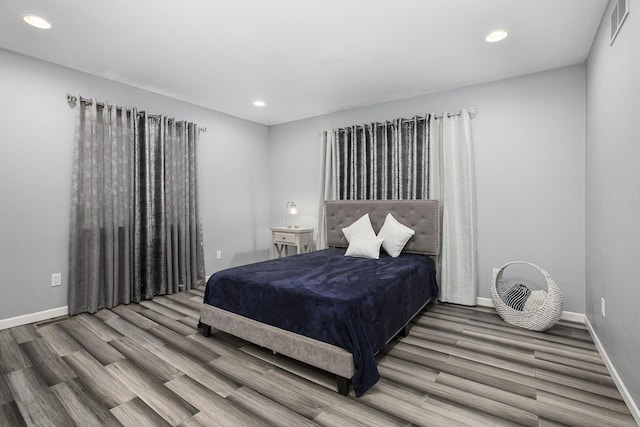 bedroom with hardwood / wood-style flooring