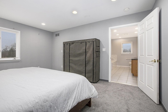 carpeted bedroom featuring connected bathroom