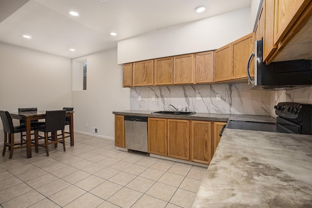 kitchen featuring tasteful backsplash, sink, light tile patterned floors, and appliances with stainless steel finishes