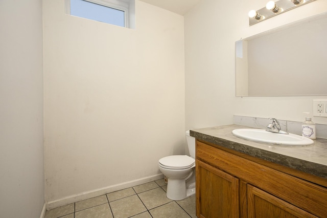 bathroom with tile patterned flooring, vanity, and toilet