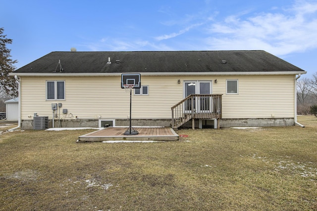 rear view of house with a lawn and central air condition unit