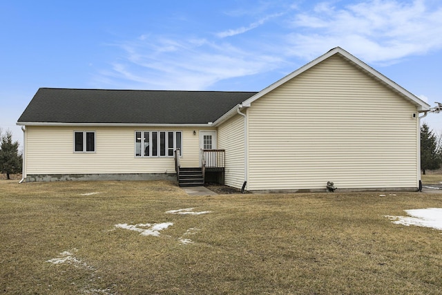 back of property featuring a lawn