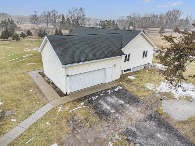 view of side of property with a garage and a yard