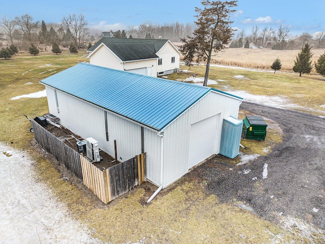 view of outdoor structure with ac unit and a lawn