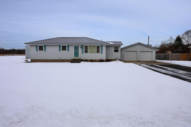 ranch-style house with a garage and an outbuilding