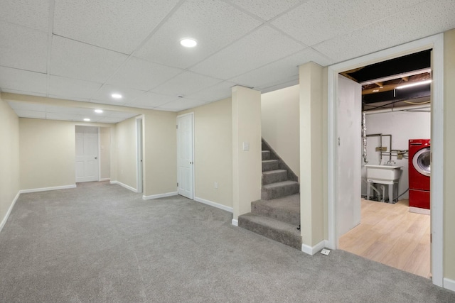 basement featuring washer / clothes dryer, carpet flooring, and a paneled ceiling