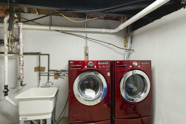 washroom featuring sink and washing machine and clothes dryer