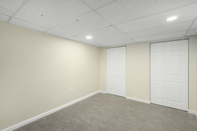 unfurnished bedroom featuring a paneled ceiling and carpet floors