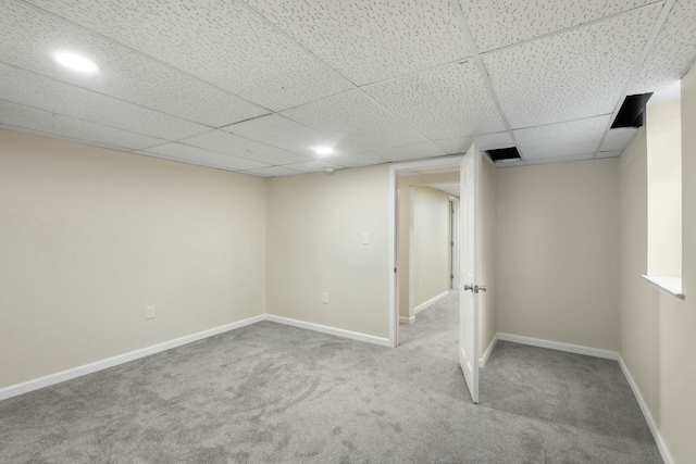 basement with carpet flooring and a drop ceiling