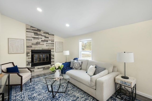 living room featuring hardwood / wood-style flooring, a fireplace, and vaulted ceiling