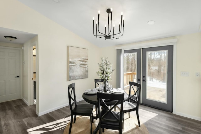 dining room featuring french doors, lofted ceiling, dark hardwood / wood-style floors, and a chandelier