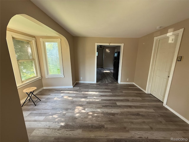 2372 E Boatfield Ave, Burton, MI 48529 - spare room with dark wood-type flooring and arched walkways