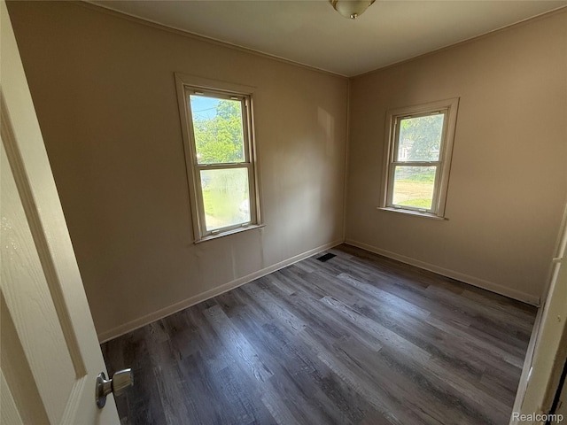 2372 E Boatfield Ave, Burton, MI 48529 - empty room featuring healthy amount of natural light and dark wood-style floors