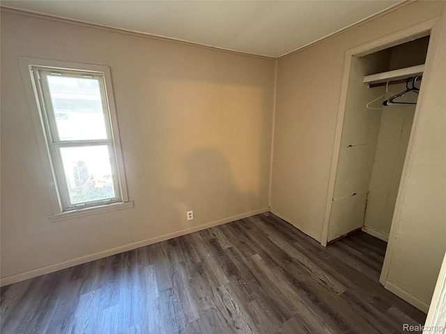2372 E Boatfield Ave, Burton, MI 48529 - unfurnished bedroom featuring dark wood-style floors and a closet