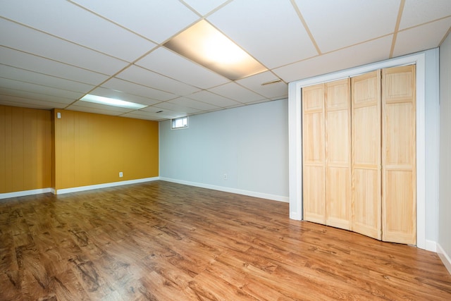 basement with wood-type flooring and a drop ceiling