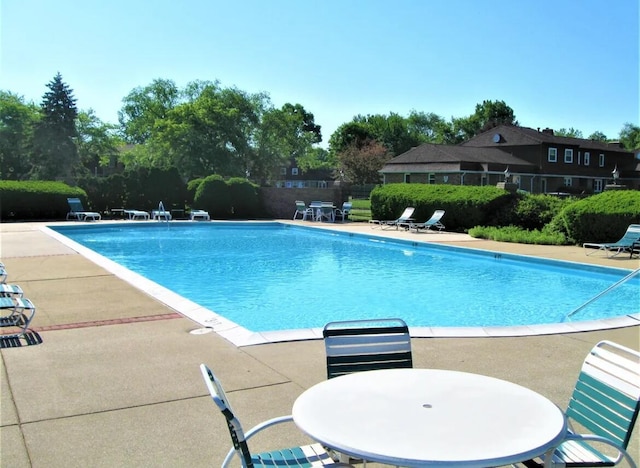 view of swimming pool featuring a patio area