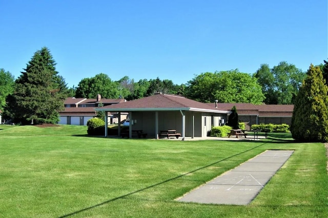 back of house with a lawn