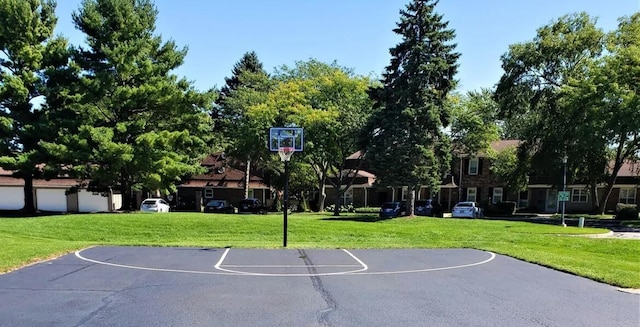 view of sport court featuring a yard