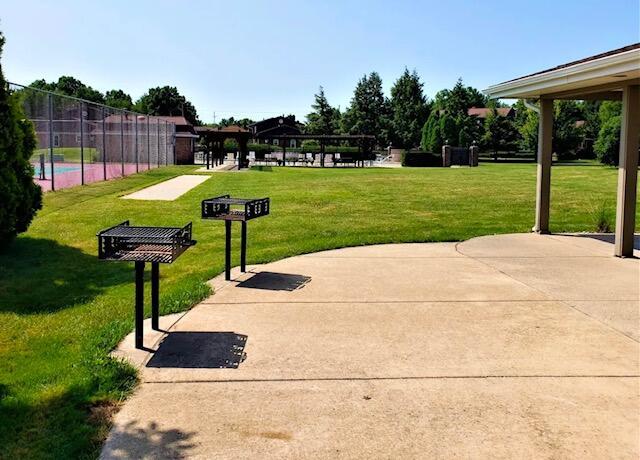 surrounding community with a yard and a patio