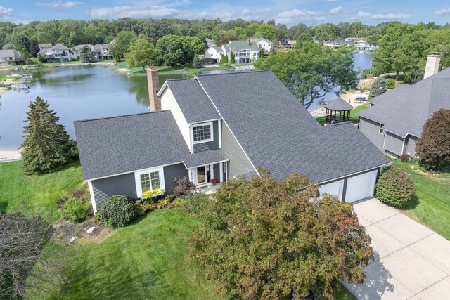 birds eye view of property with a water view