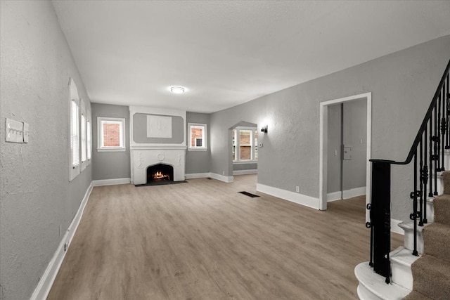 unfurnished living room with hardwood / wood-style flooring