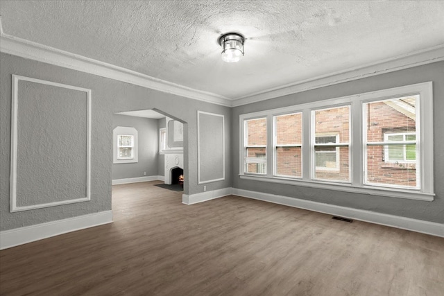 unfurnished living room featuring crown molding, hardwood / wood-style floors, and a textured ceiling