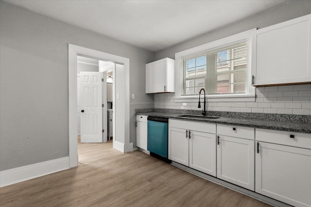 kitchen with sink, stainless steel dishwasher, white cabinets, and light wood-type flooring